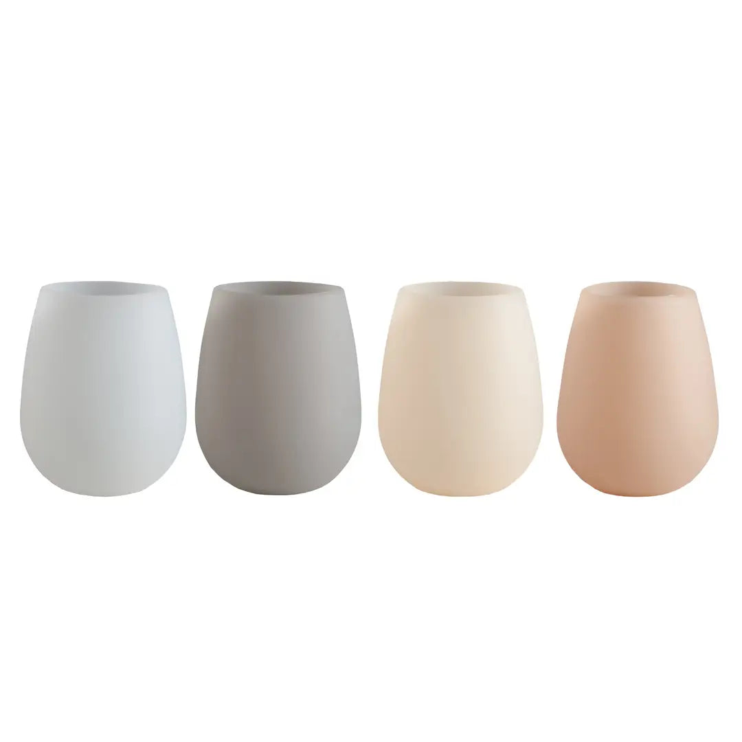 Four silicone glasses in different colors on a white background