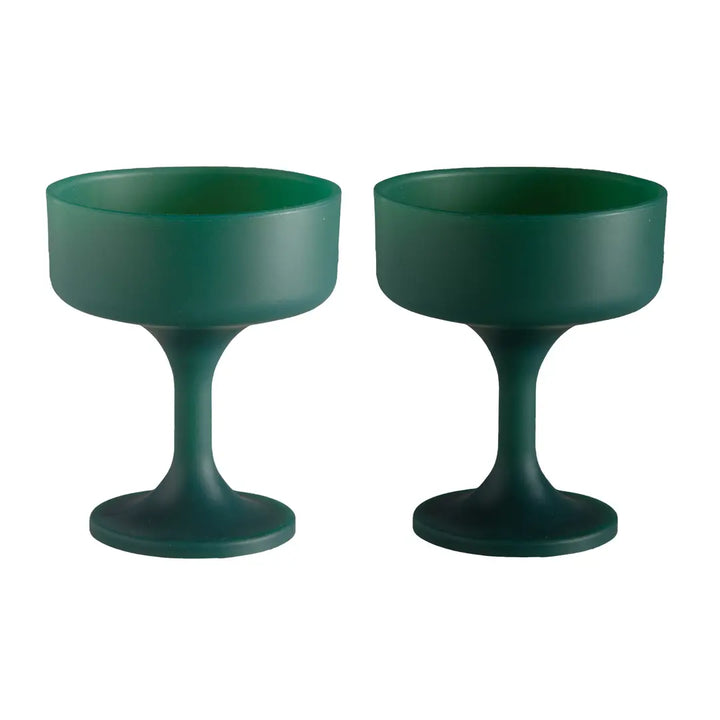 Two dark green silicone unbreakable cocktail glasses with wide, shallow circular rims, shown side by side on a plain white background.
