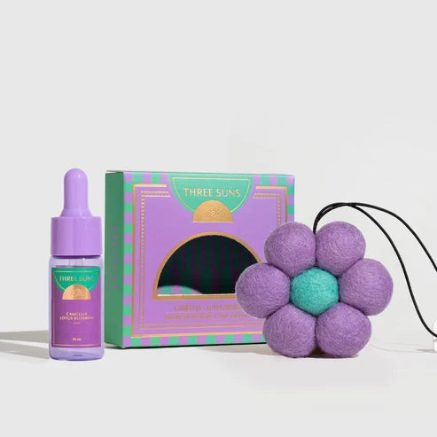 Three Suns product set including a dropper bottle, box, and purple flower-shaped item on a white background