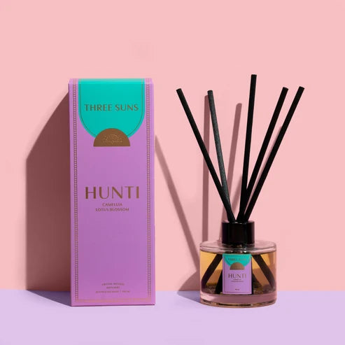 A Three Suns Hunti diffuser and box on a pale pink background