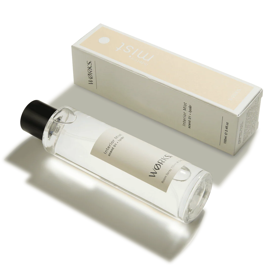 Clear bottle with black cap and beige label next to a beige box labeled &