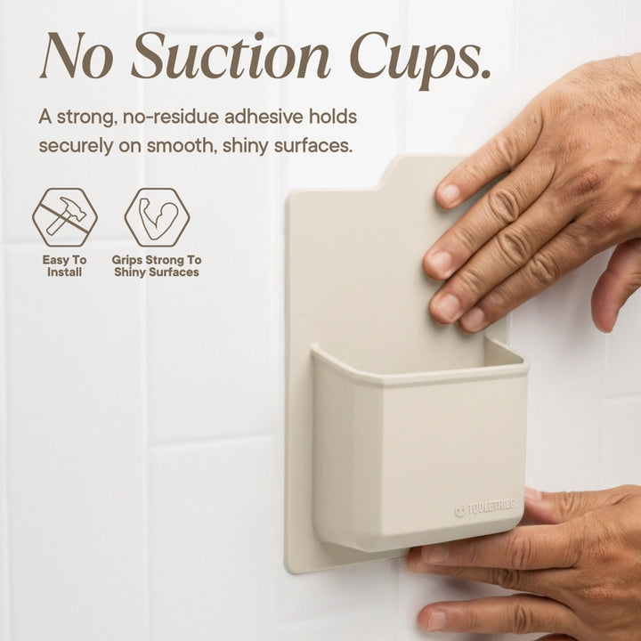 A beige wall-mounted suction cup holder being pressed onto a glossy white tiled wall by two hands. Large text at the top reads &