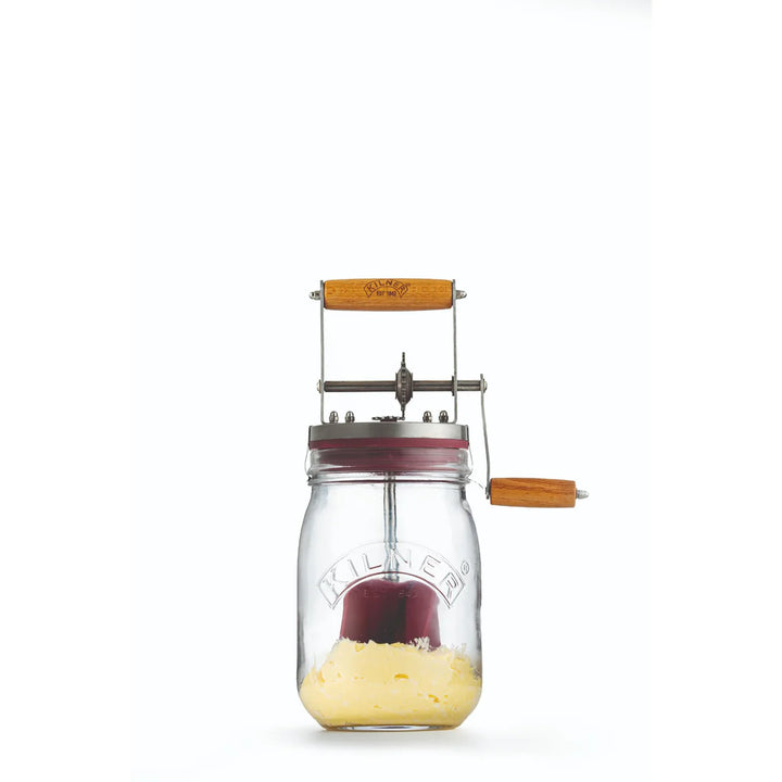 Glass jar butter churner on a white background