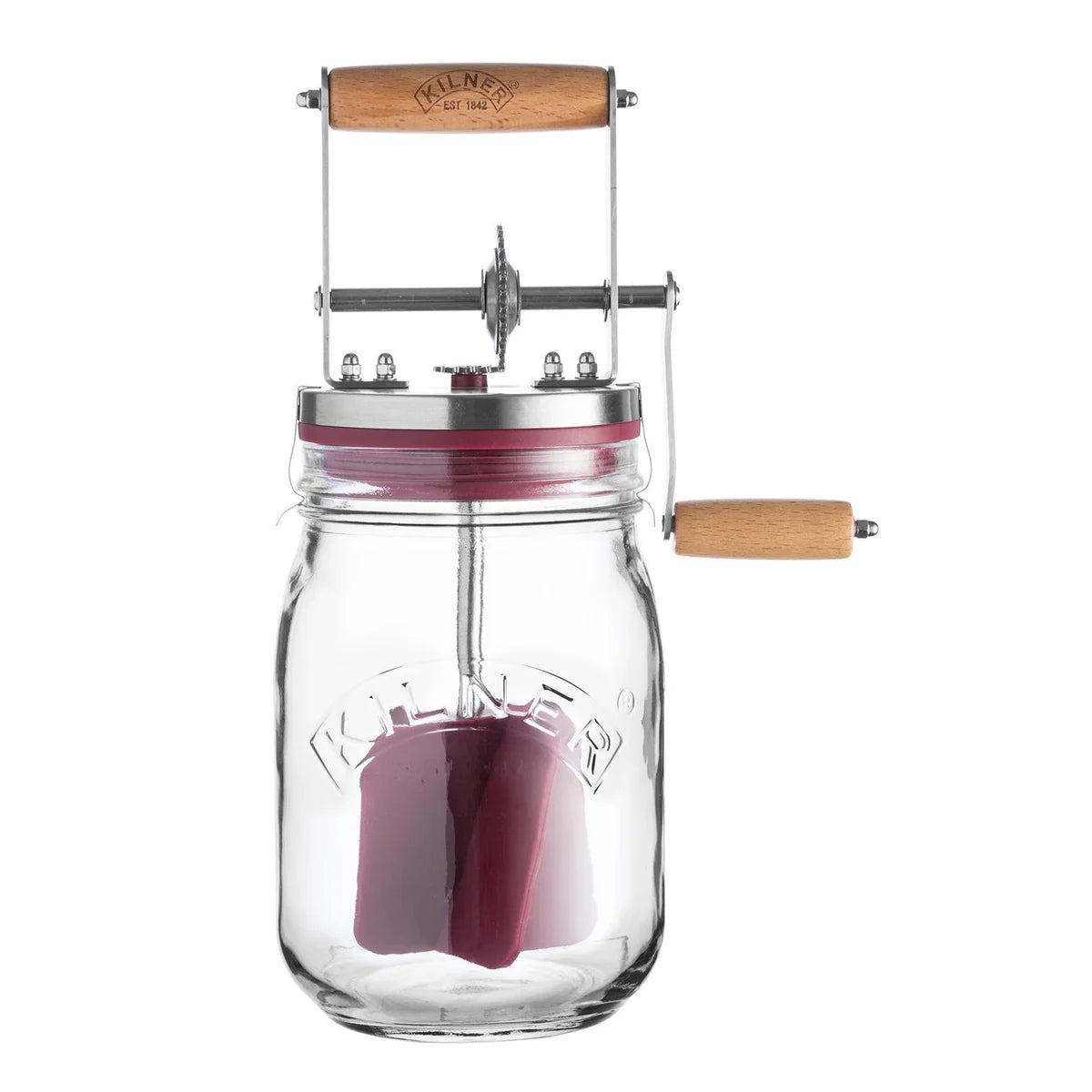 Clear glass butter churner with wooden handle and metal lever on a white background