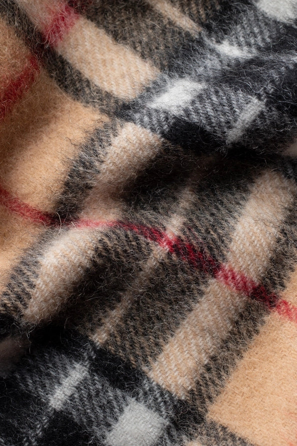 Close-up of a checkered fabric with red, beige, and black colors.