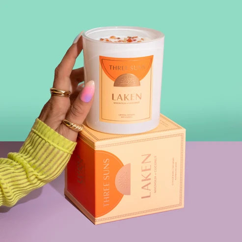 Hand holding a candle labeled &