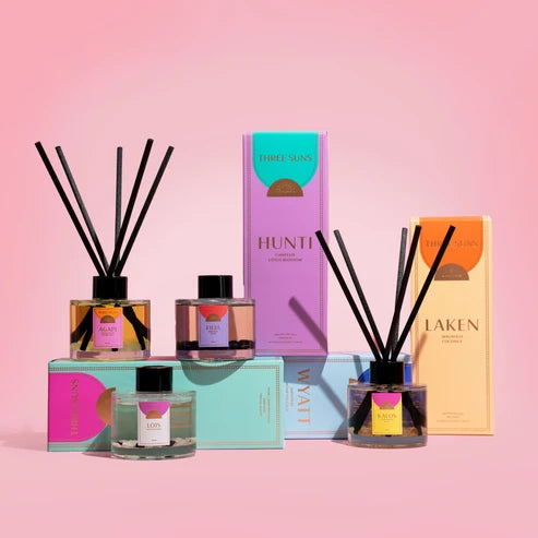 Collection of diffusers and boxes on a pink background