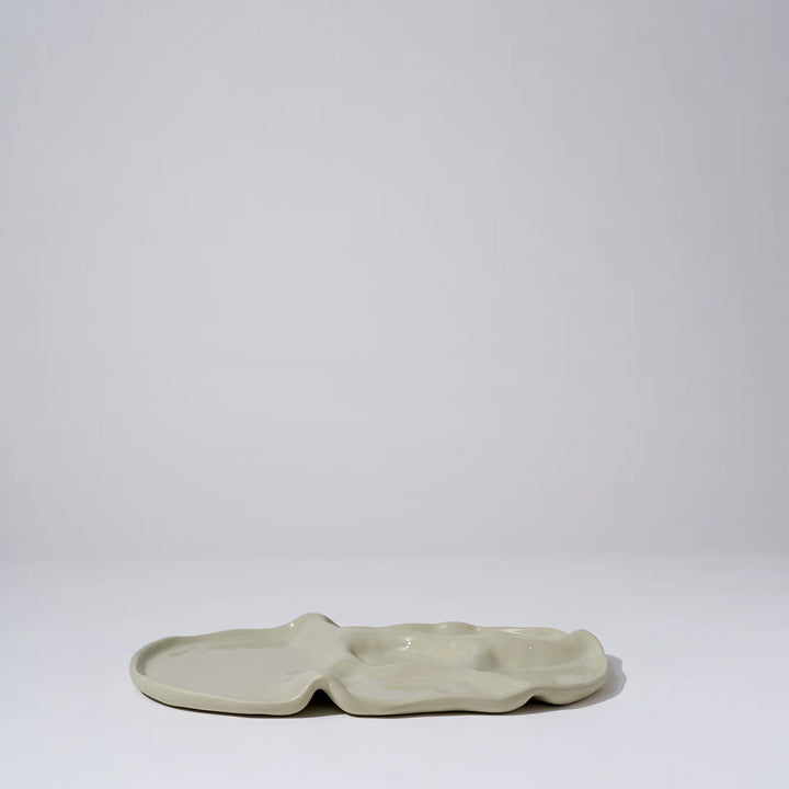 Ceramic dish with wavy edges on a white background