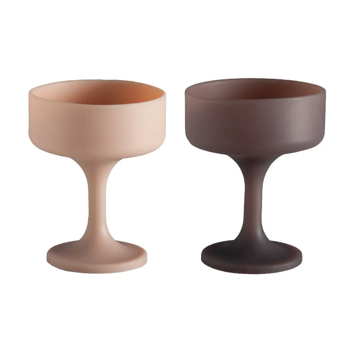 Two silicone unbreakable cocktail glasses, one beige and one brown, on a white background