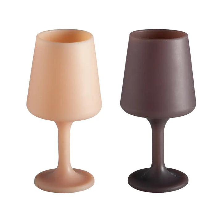Two wine glasses, one beige and one brown, on a white background
