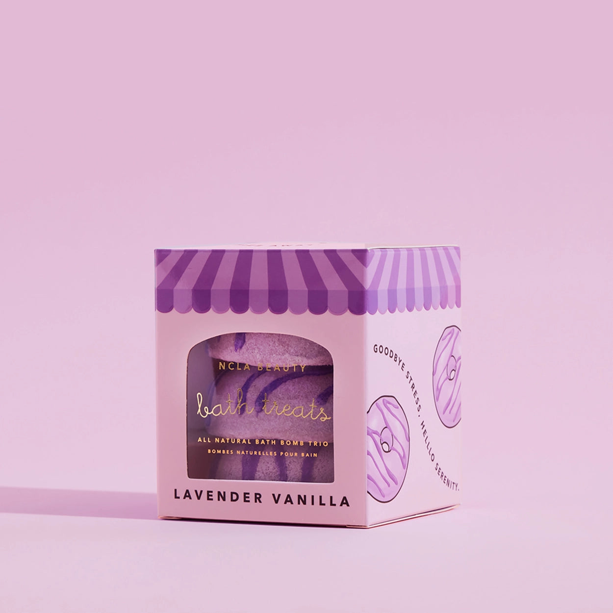 Pink and purple packaging of a bath product on a pink background