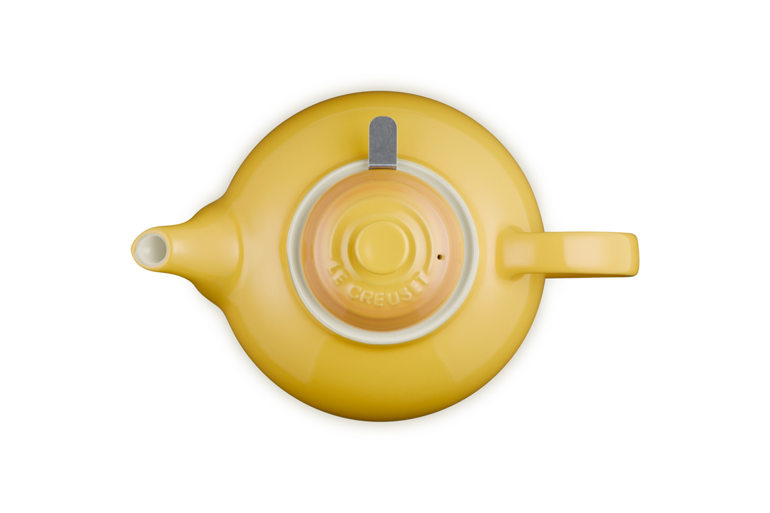 Yellow teapot with a white interior on a white background