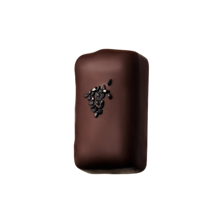 A chocolate with black sesame seeds on it 