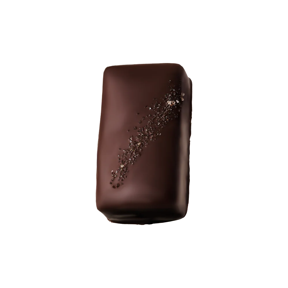 A single chocolate-covered rectangular chocolate bar with a glossy dark brown finish and a diagonal sprinkle of coarse chocolate flakes, isolated on a solid black background.