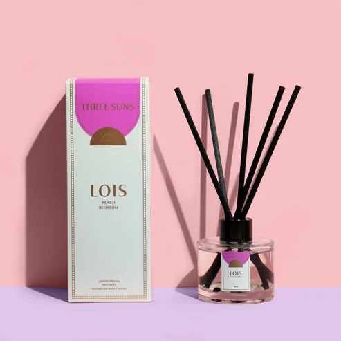 Three Suns Lois reed diffuser and box on a pink background
