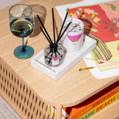 Three Suns Lois reed diffuser &amp; candle on a marble tray on a table