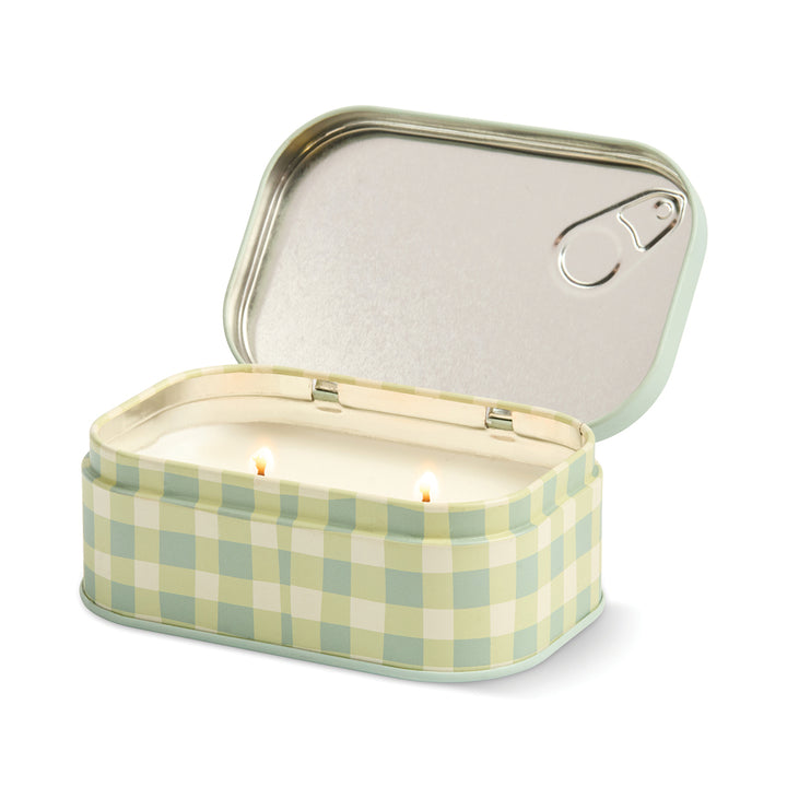 Checkered candle in a tin with a lid on a white background