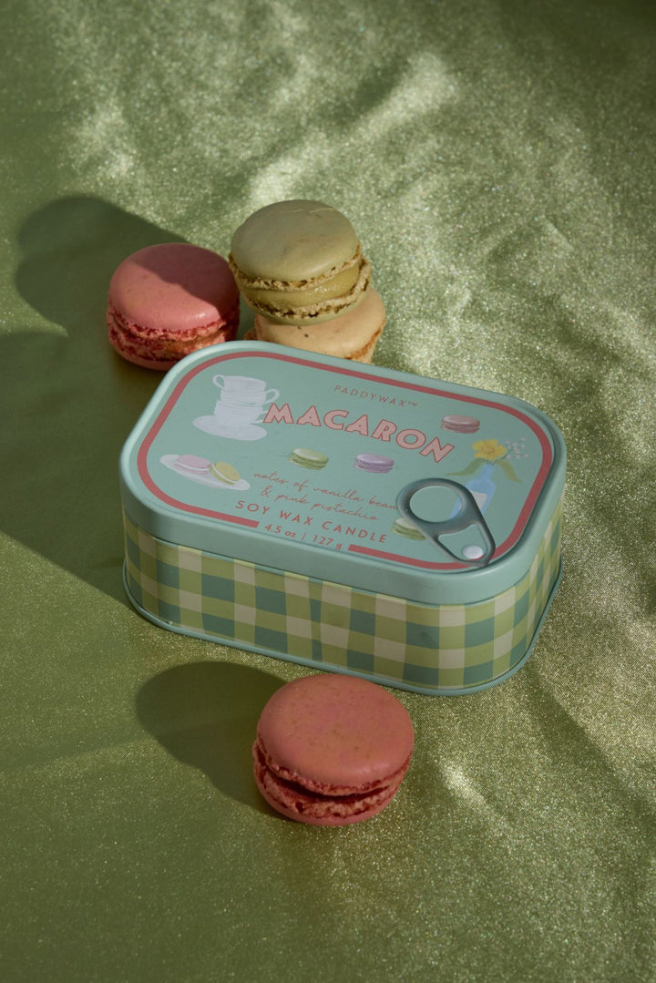 A decorative tin candle labeled &