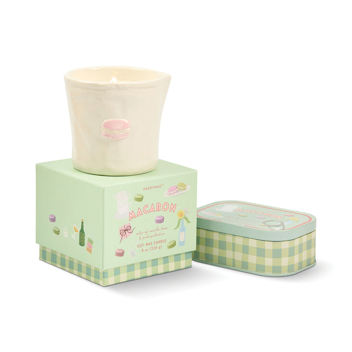 Candle in a decorative box with a checkered lid on a white background