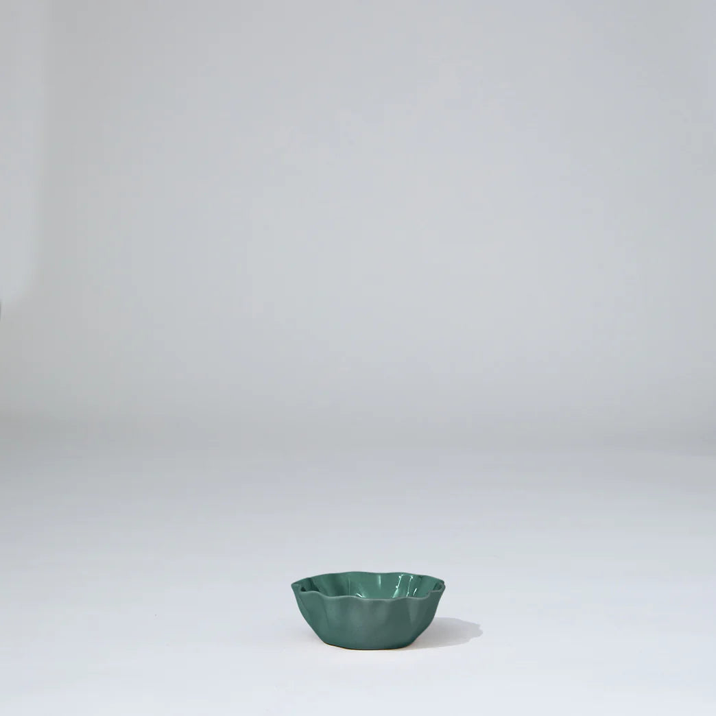 Green ceramic bowl on a white background