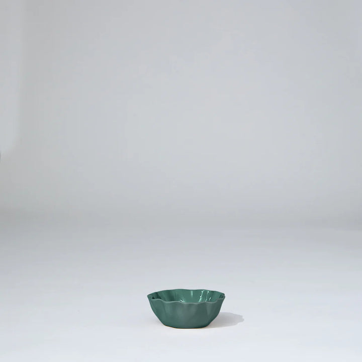 Green ceramic bowl on a white background
