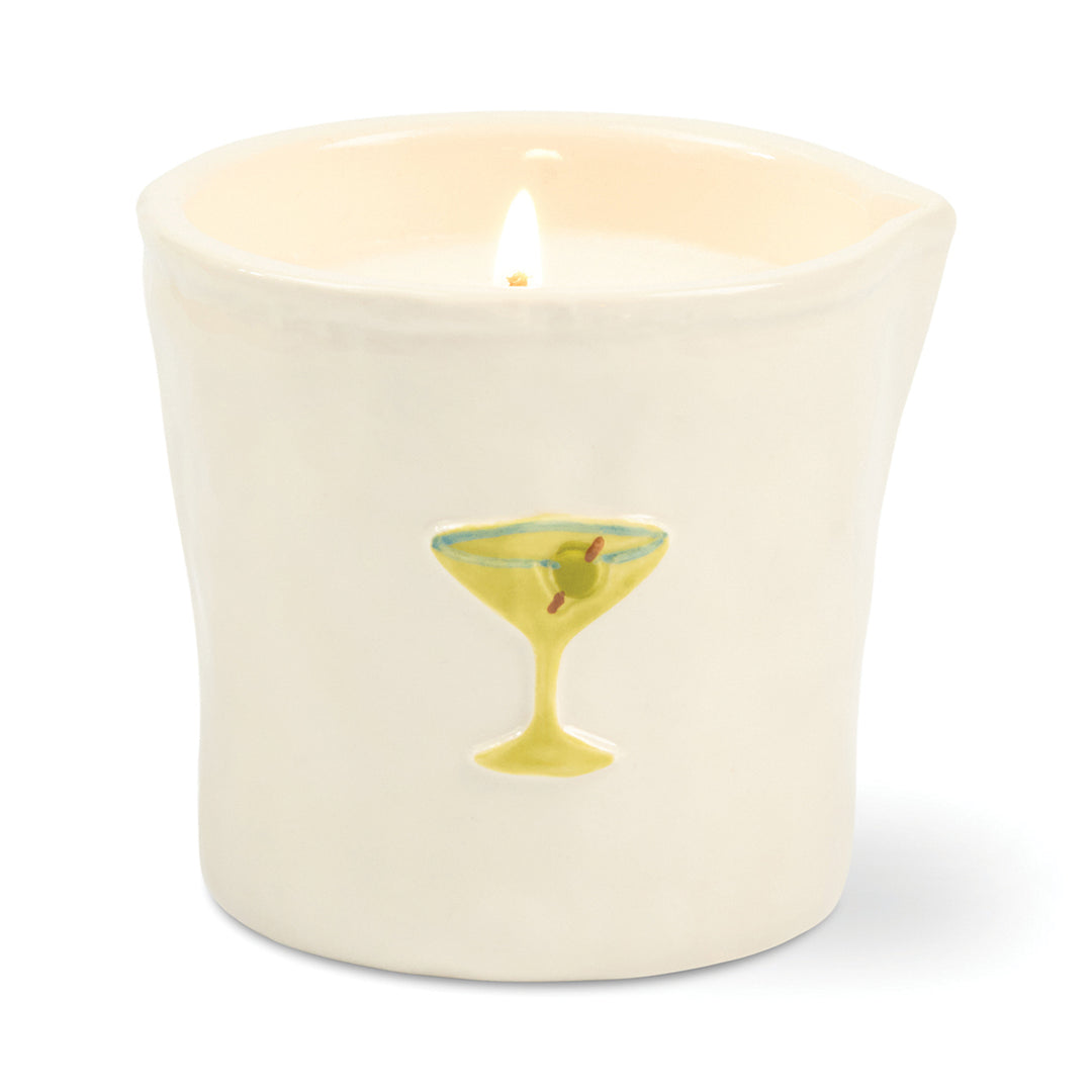 Candle in a white ceramic container with a design of a cocktail glass on a white background