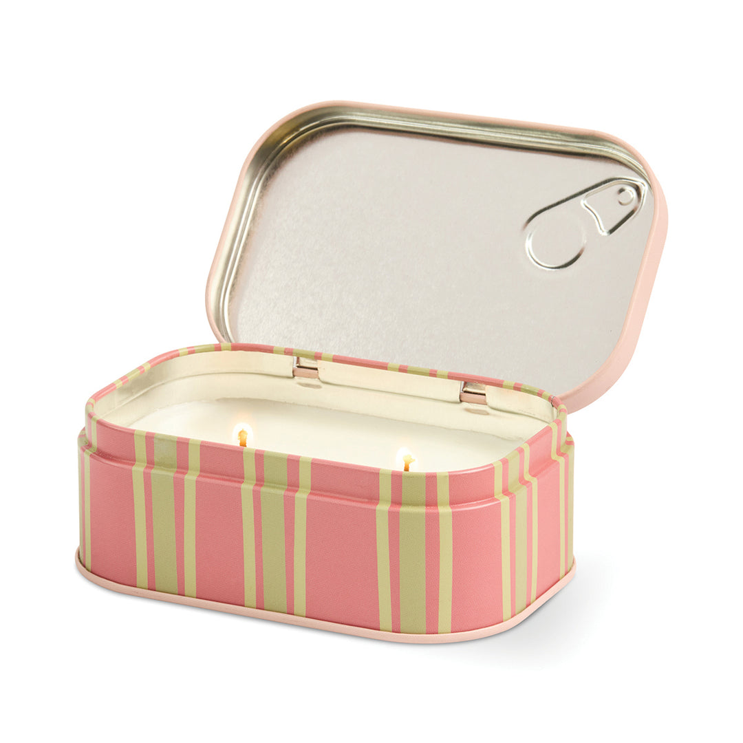 Striped candle in a tin with a lid on a white background