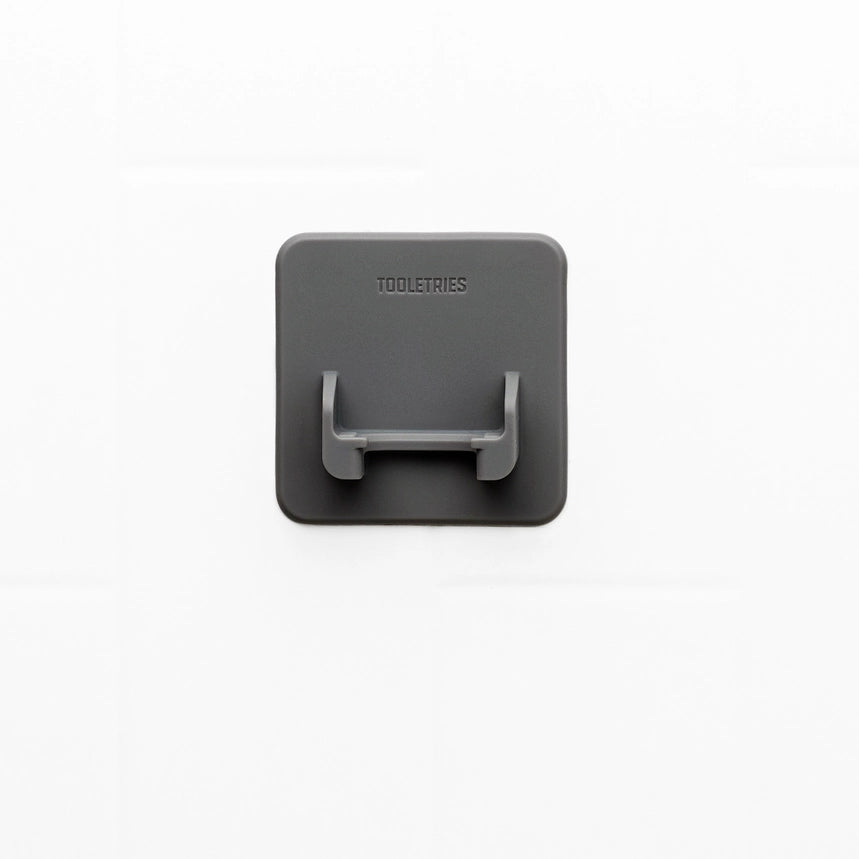 Grey square silicone razor holder on a white background
