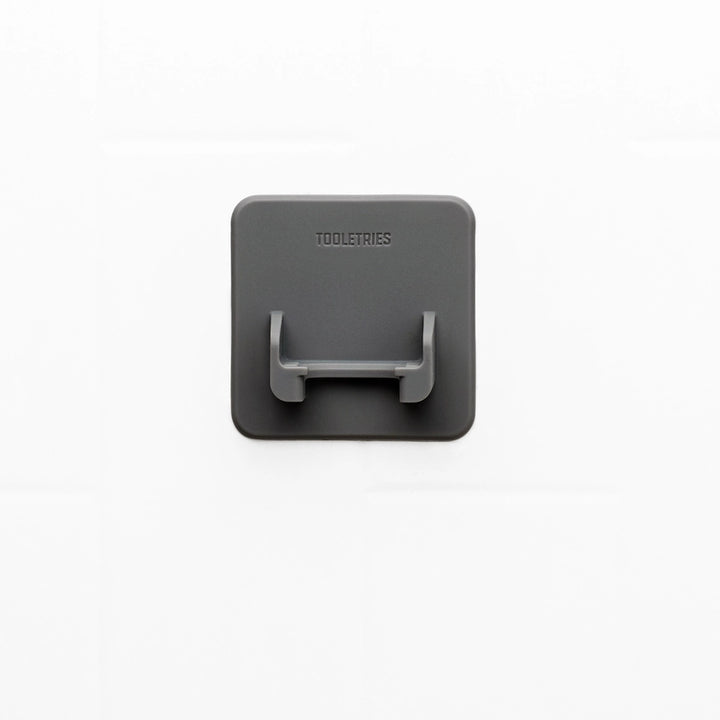 Grey square silicone razor holder on a white background