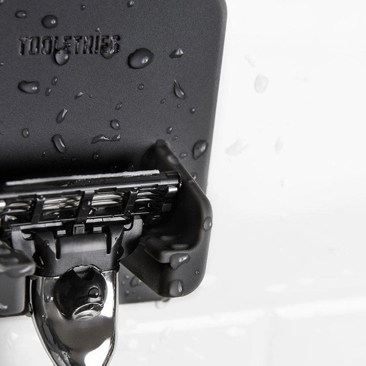 Close up of a grey silicone razor holder on a white background