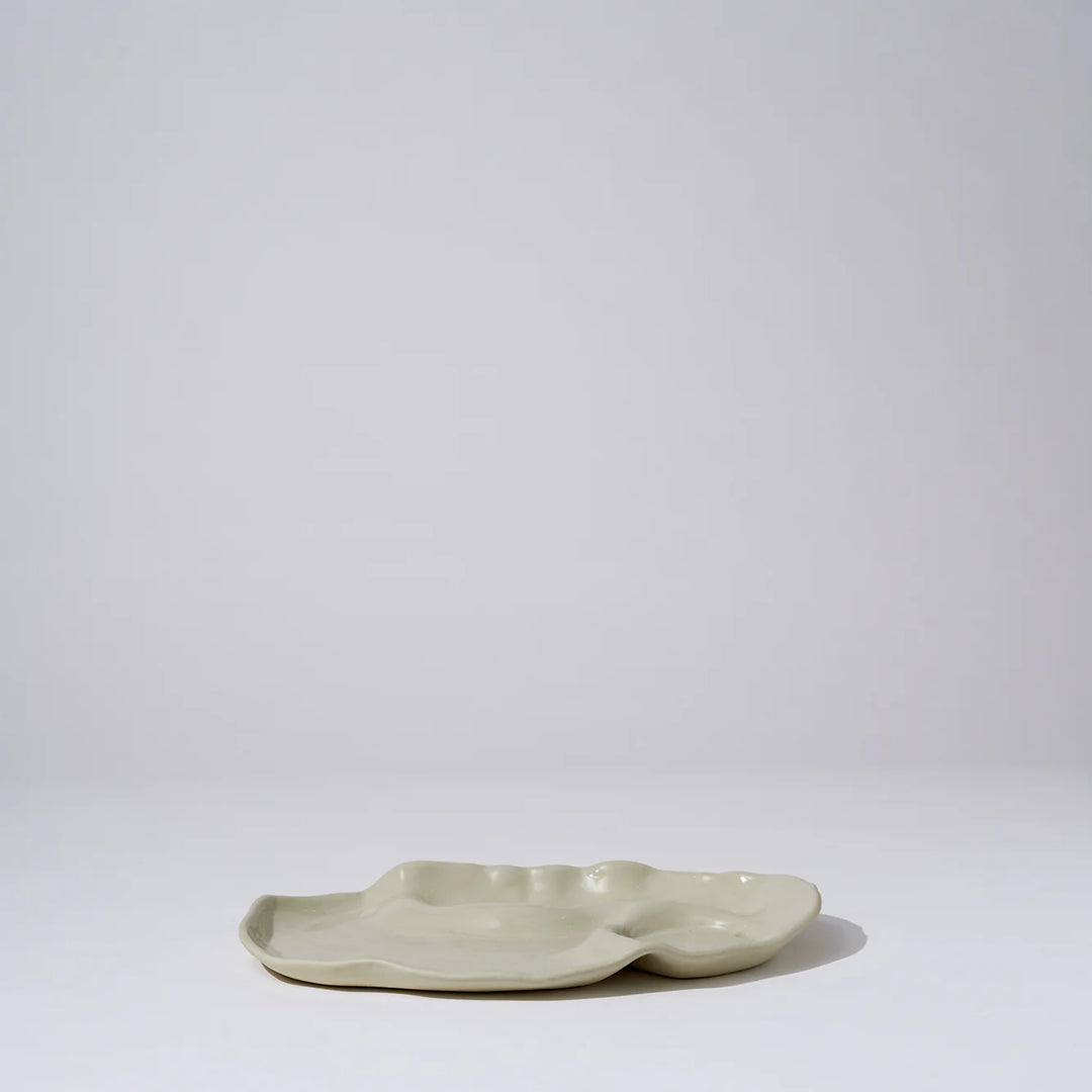 Ceramic dish with a wavy edge on a white background
