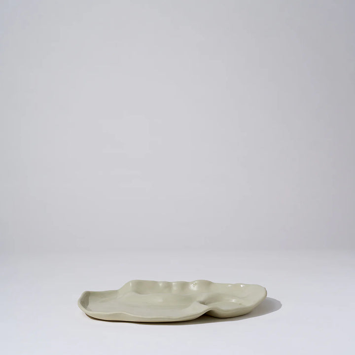 Ceramic dish with a wavy edge on a white background