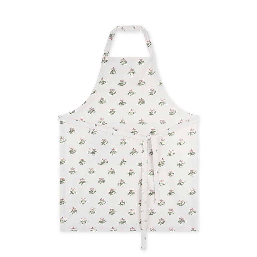 Cream coloured cotton apron with repeated mistletoe print on a white background