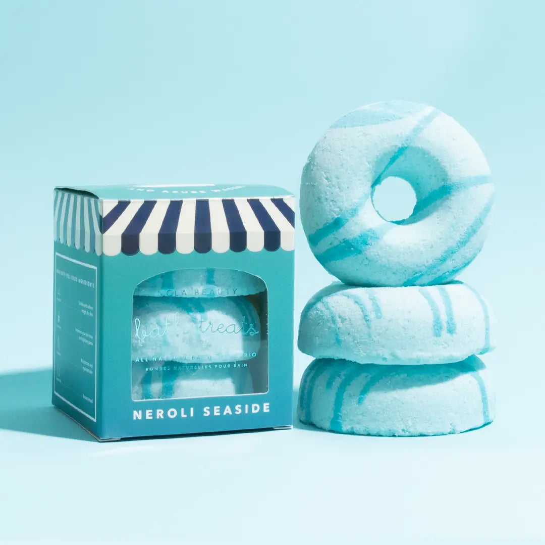 Stack of blue bath bombs with a striped box labeled &