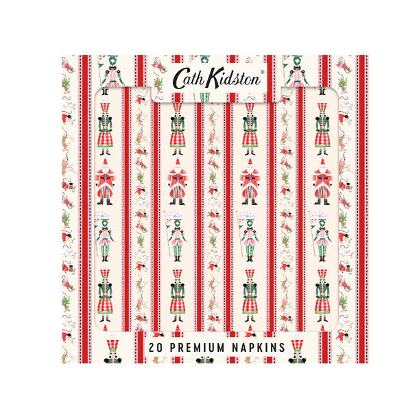 A pack of Cath Kidston 20 premium napkins featuring a festive vertical striped pattern with red and white stripes, green and red nutcracker figures, and small holiday motifs on an off-white background.