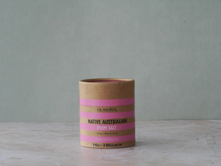 Brown paper container with pink stripes on a gray background