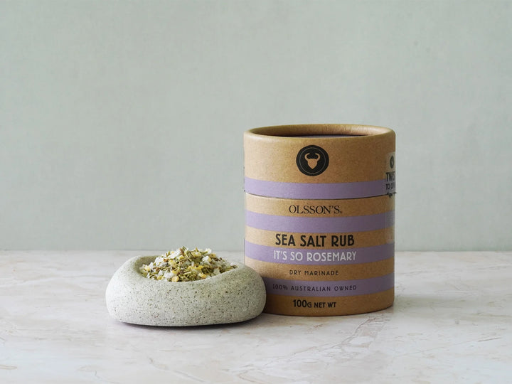 Sea salt rub container with a small dish of salt on a light surface