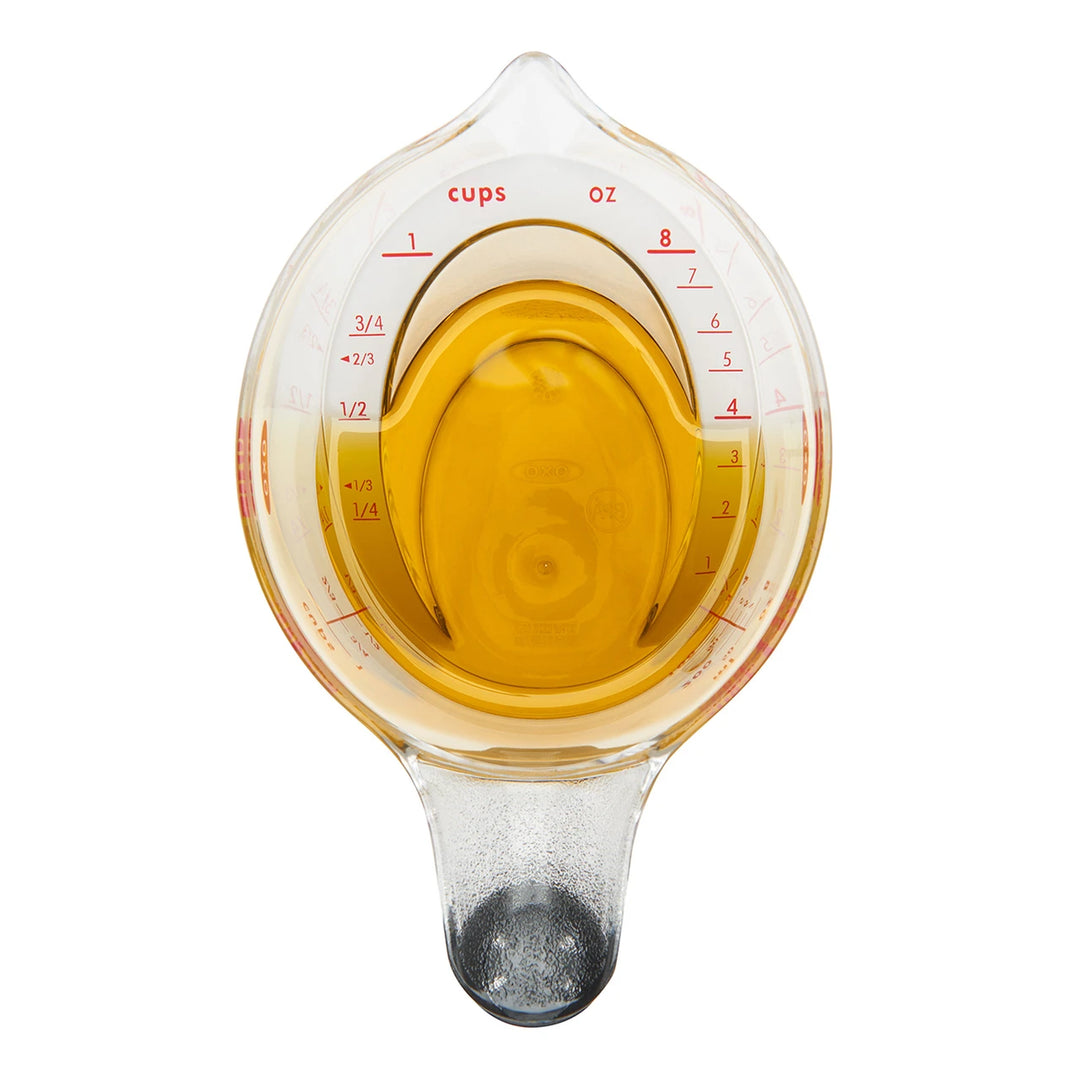 Measuring cup with liquid on a white background