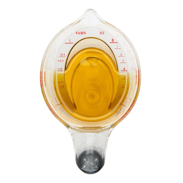 Measuring cup with liquid on a white background