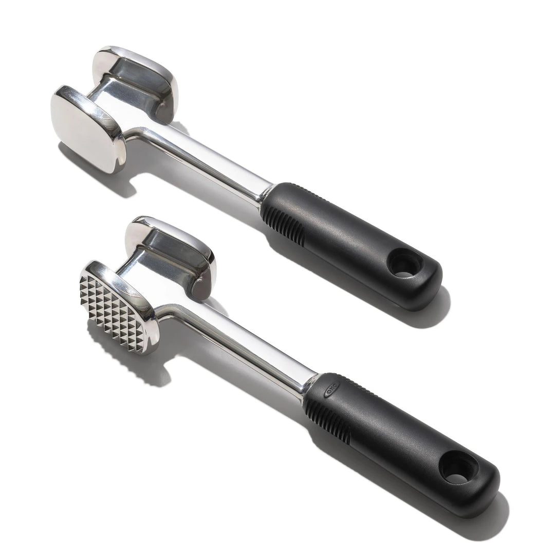 Two meat tenderizer tools with black handles on a white background