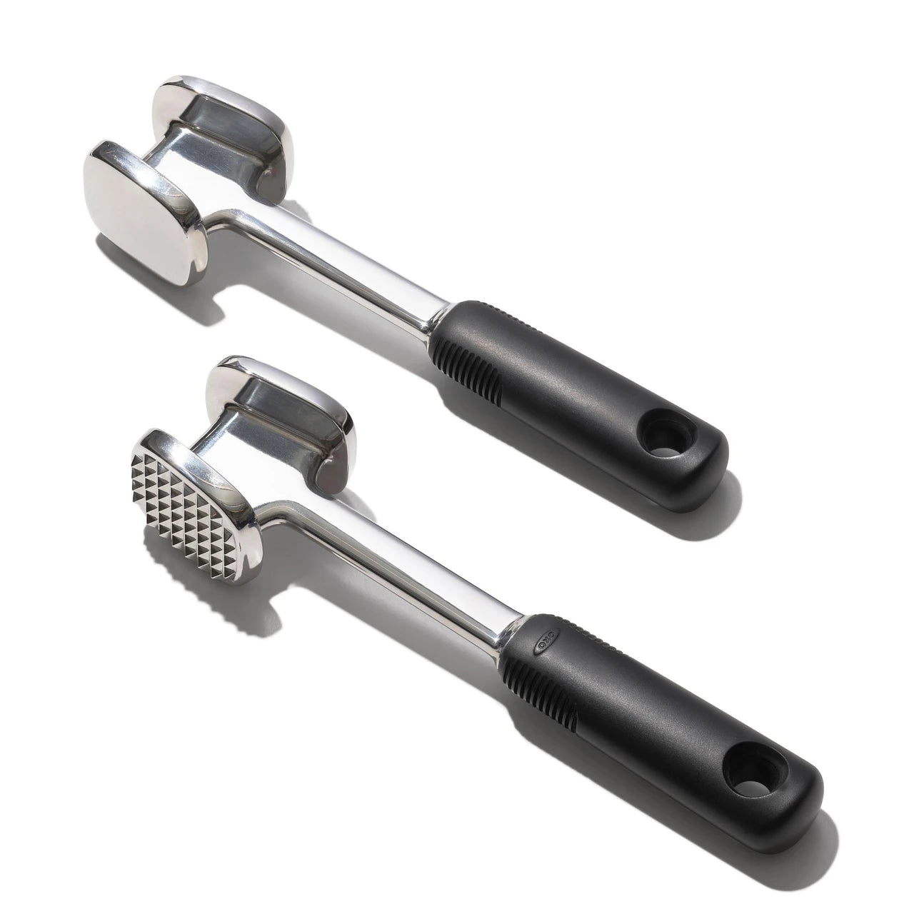 Two meat tenderizer tools with black handles on a white background