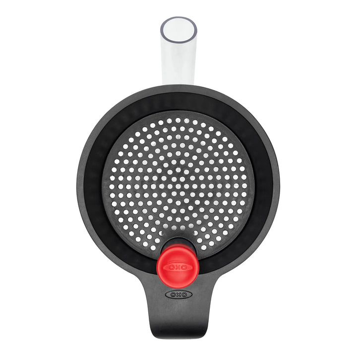 Top of fat separator jug with black strainer lid and red cap