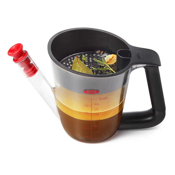 Fat separator with a black handle and black top on a white background