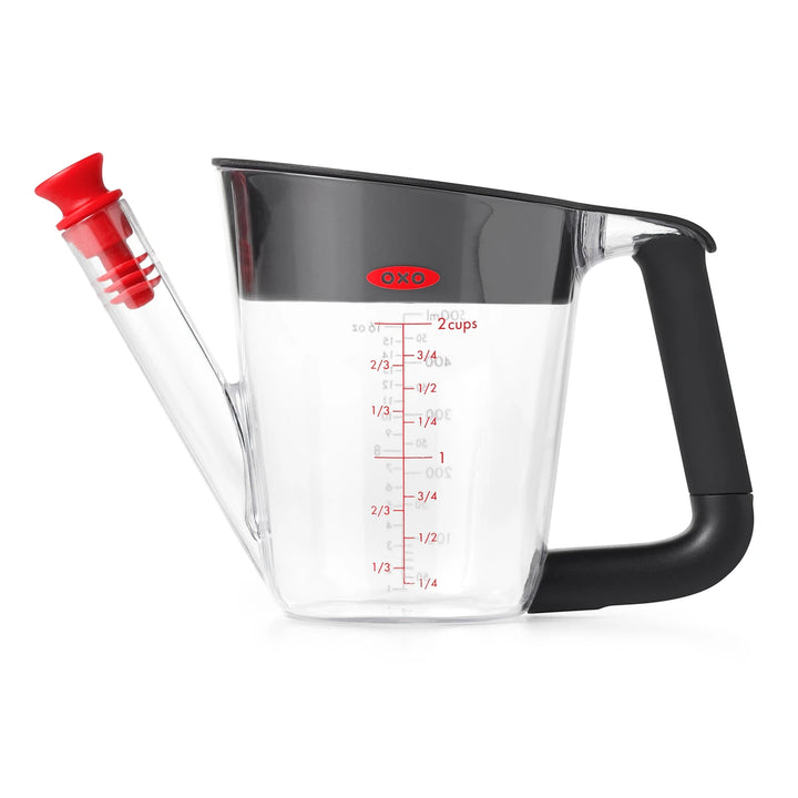 OXO fat separator measuring cup with red accents on a white background