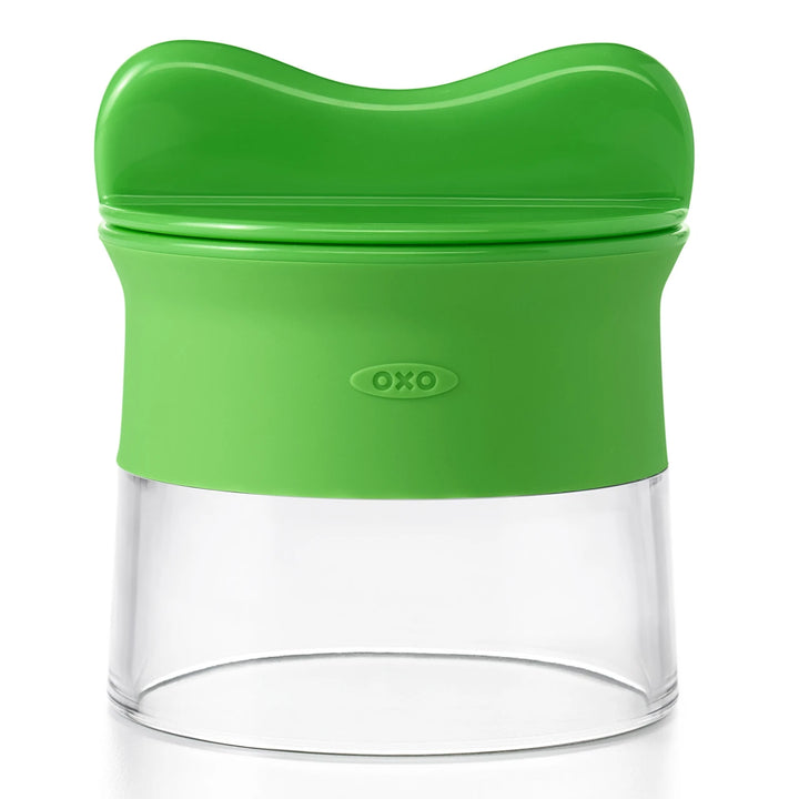 Green and clear vegetable spiralizer with OXO logo on a white background