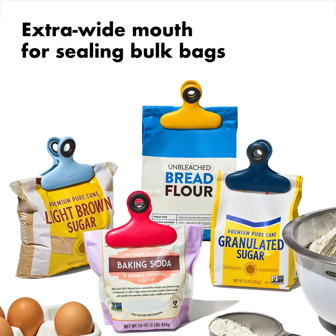 Baking ingredients with colorful sealing clips on a white background