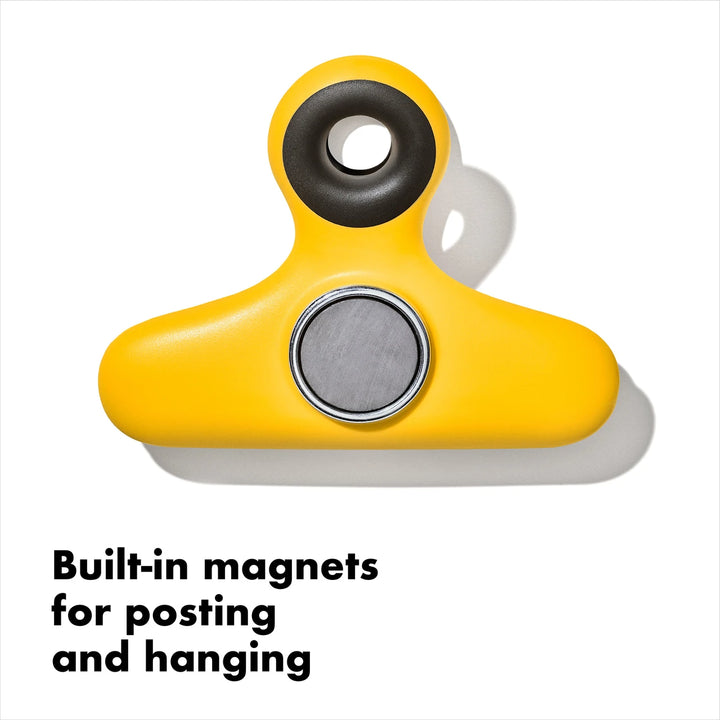 Yellow magnetic clip with built-in magnets on a white background