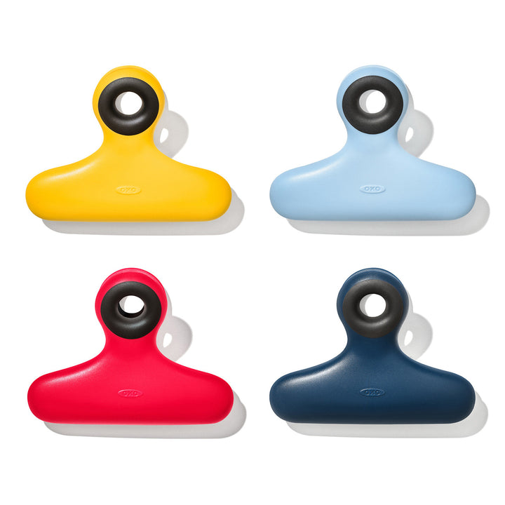 Four colorful clips in yellow, blue, red, and navy on a white background.