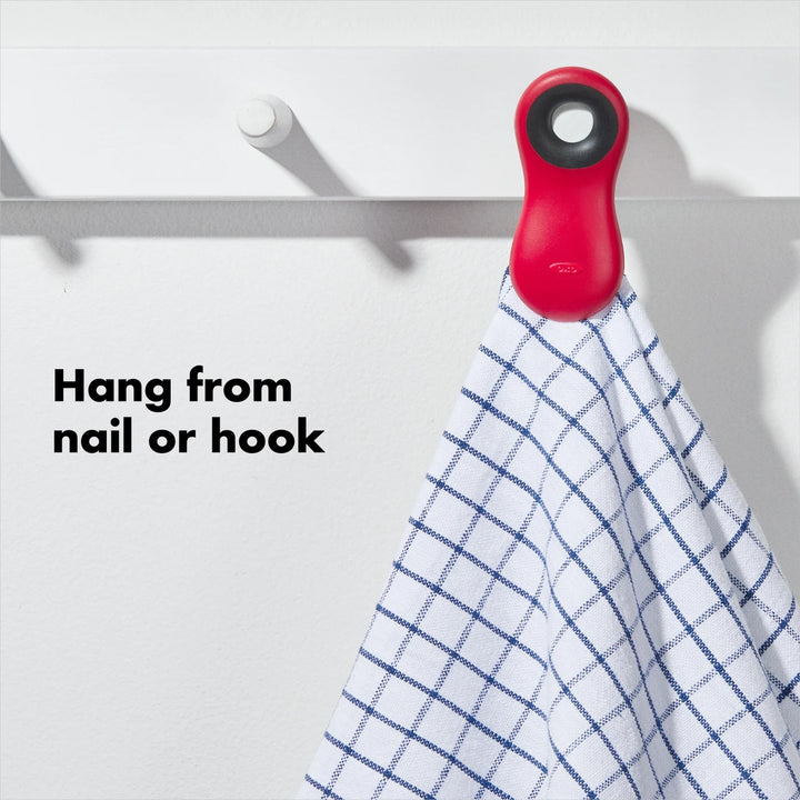 Red hook with a white towel hanging on it against a white background