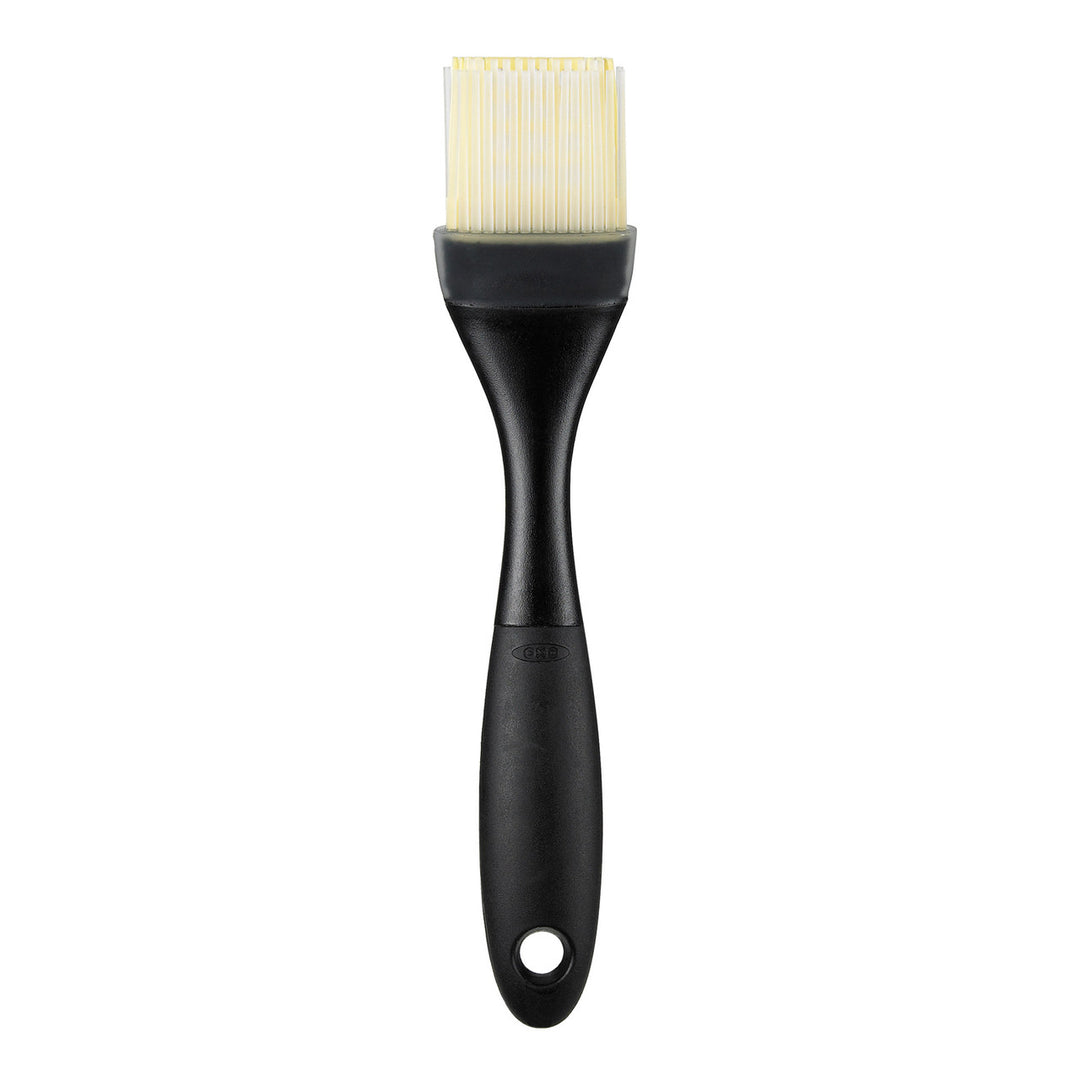 Black pastry brush with silicone bristle head on a white background